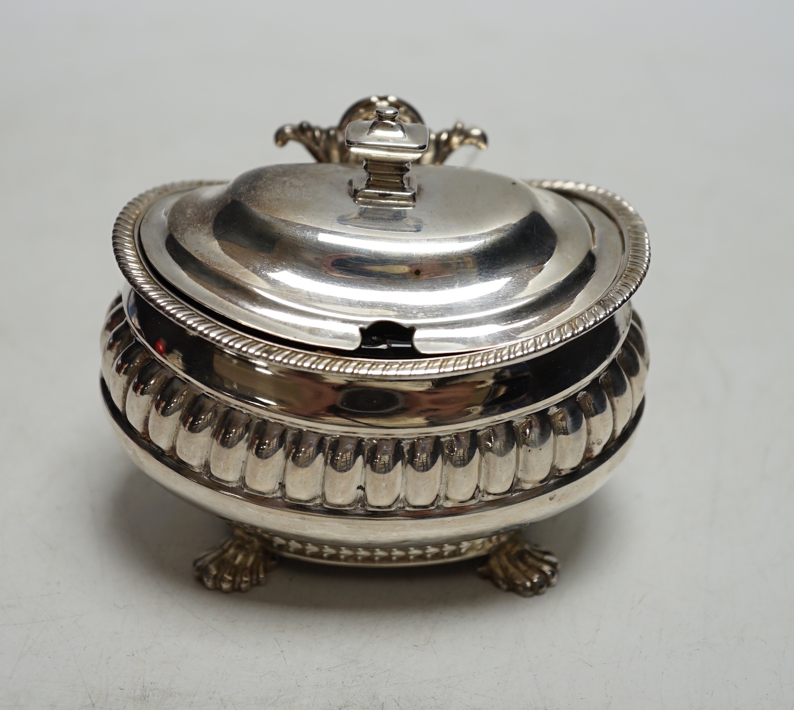 A George III demi fluted silver lidded mustard pot, London 1811 by Alexander Hewat?, length 9cm.